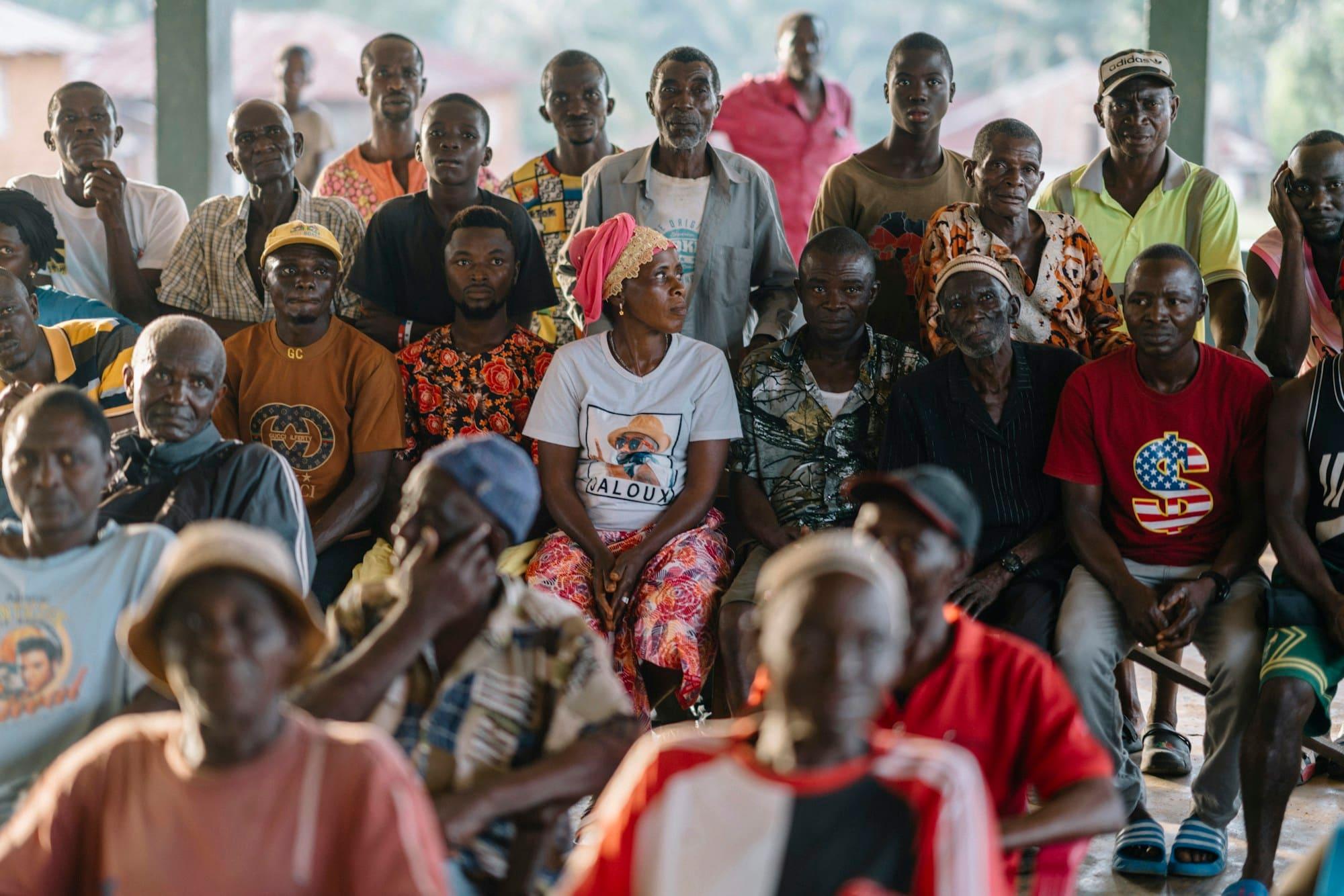 Community members of all ages seated together at a meeting